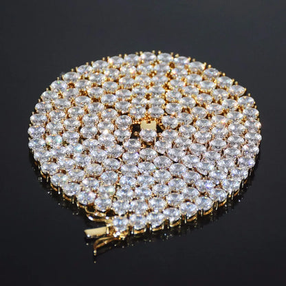 Close up of cubic zirconia tennis chain laid flat on a dark background