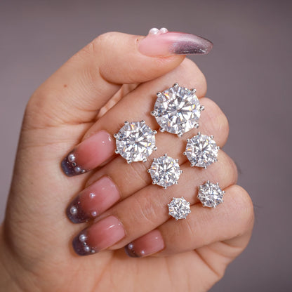 VVS Moissanite 0.5-12ct 8 Prong Stud Earrings displayed on a hand with stylish nails.